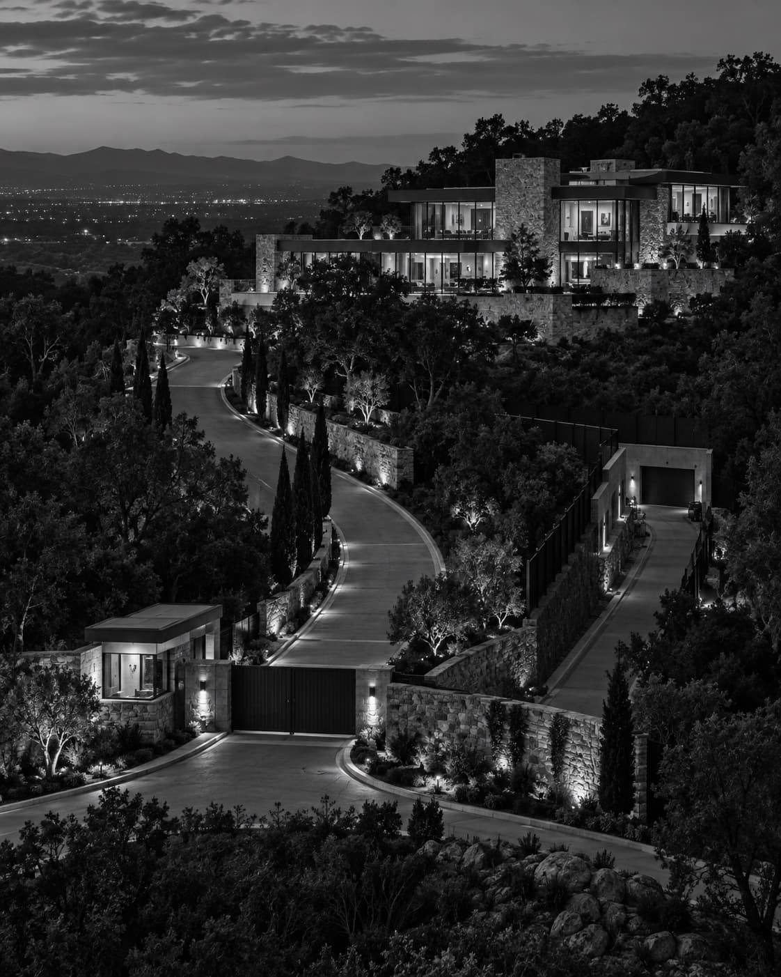 A large modern hillside residence with layered perimeter walls, gated approaches, and a separate service entrance.