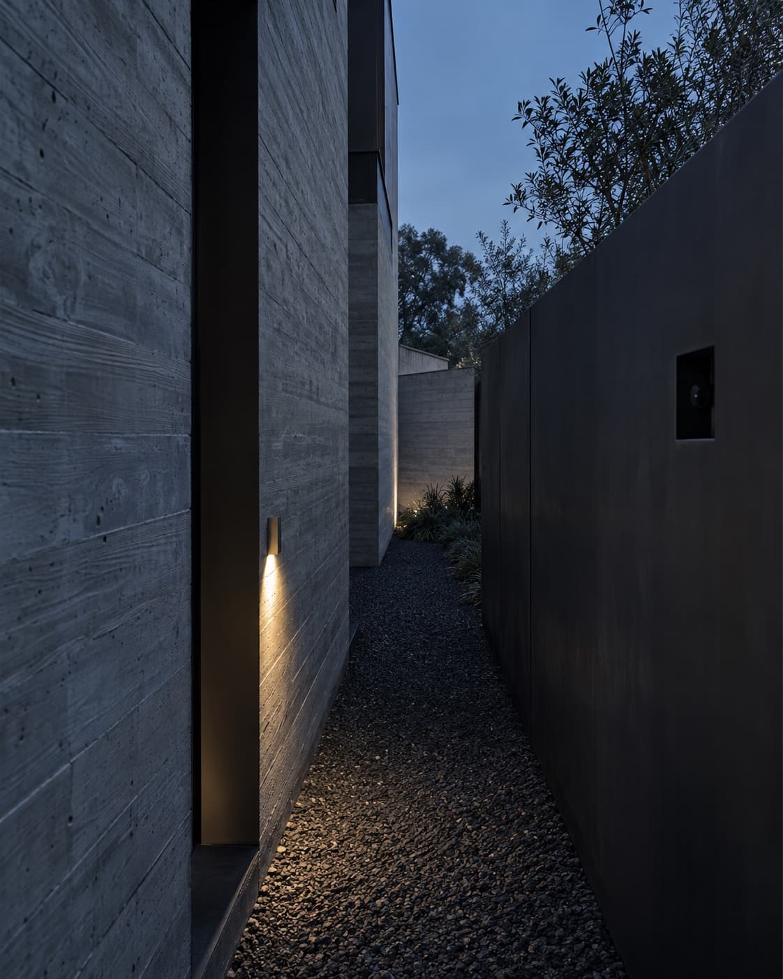 A concealed service passage between a residence and its perimeter wall.
